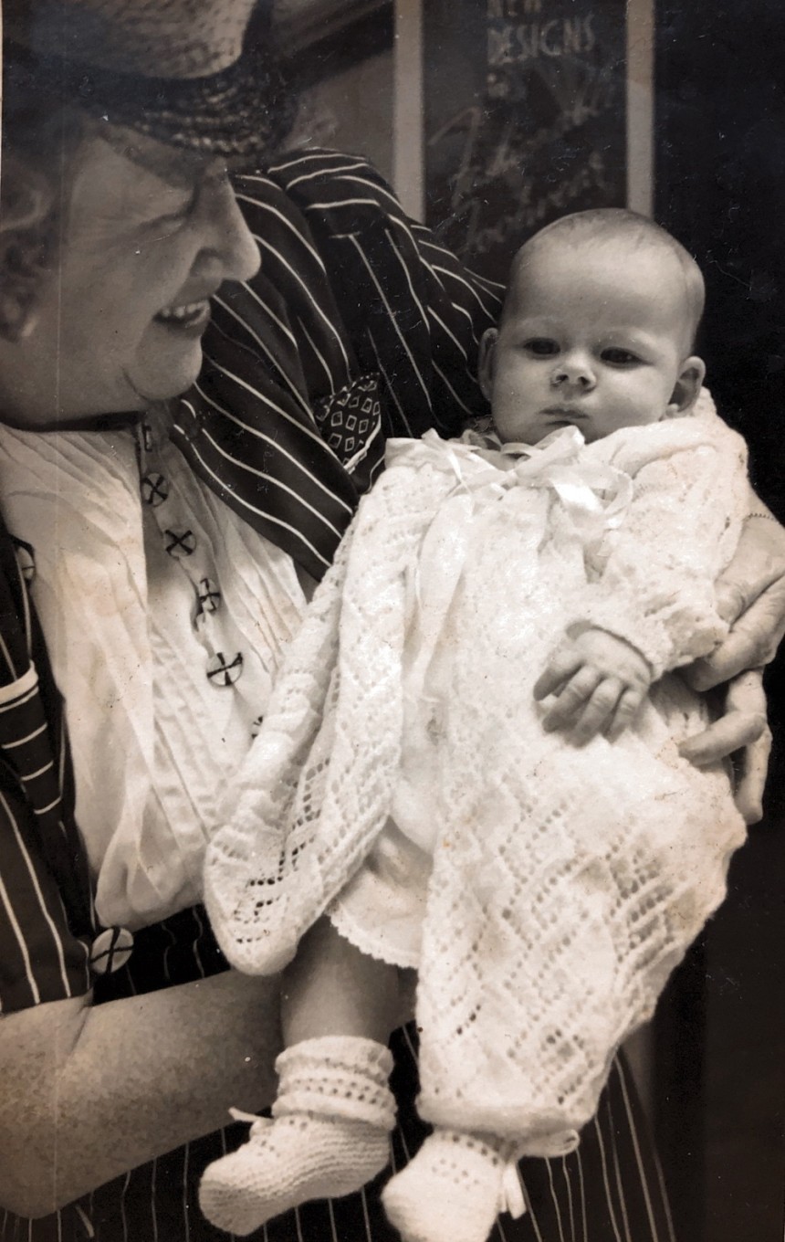 My grandmother holding me as a newborn